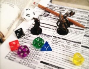 Material para jugar juegos de rol con dados, manuales y fichas de personaje sobre una mesa